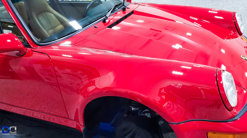 Red Porsche sports car, shiny and detailed, with tan interior.