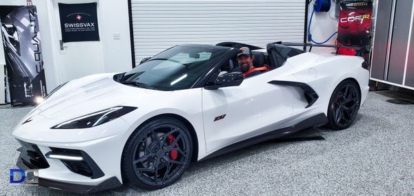 White convertible sports car parked in a garage.