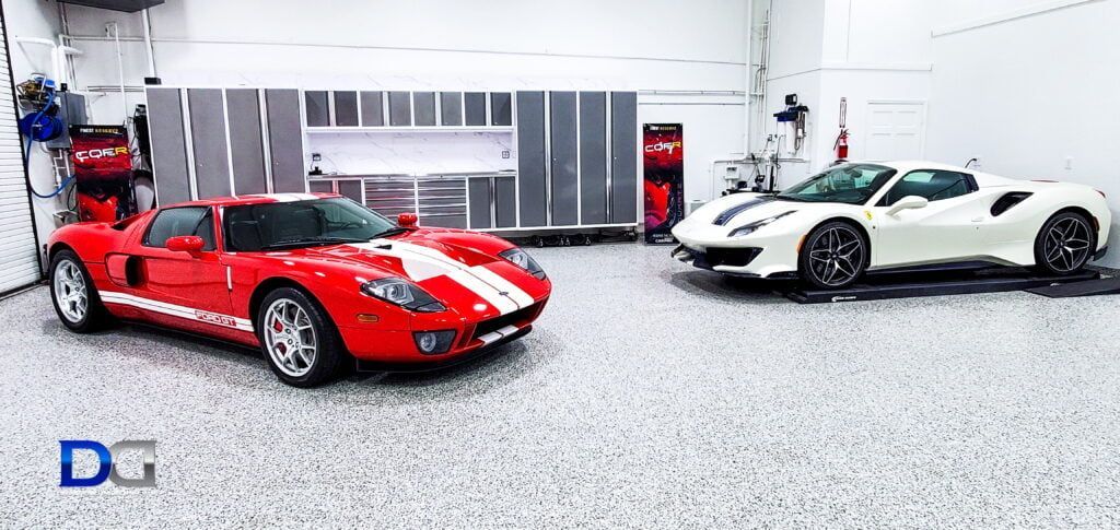 Two sports cars are parked next to each other in a garage.