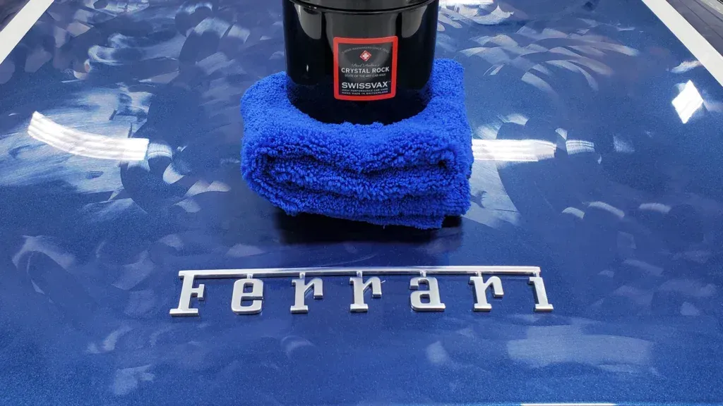 A bottle of ferrari is sitting on top of a blue towel.