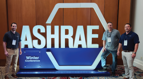 Three men are standing in front of a sign that says ashrae winter conference.