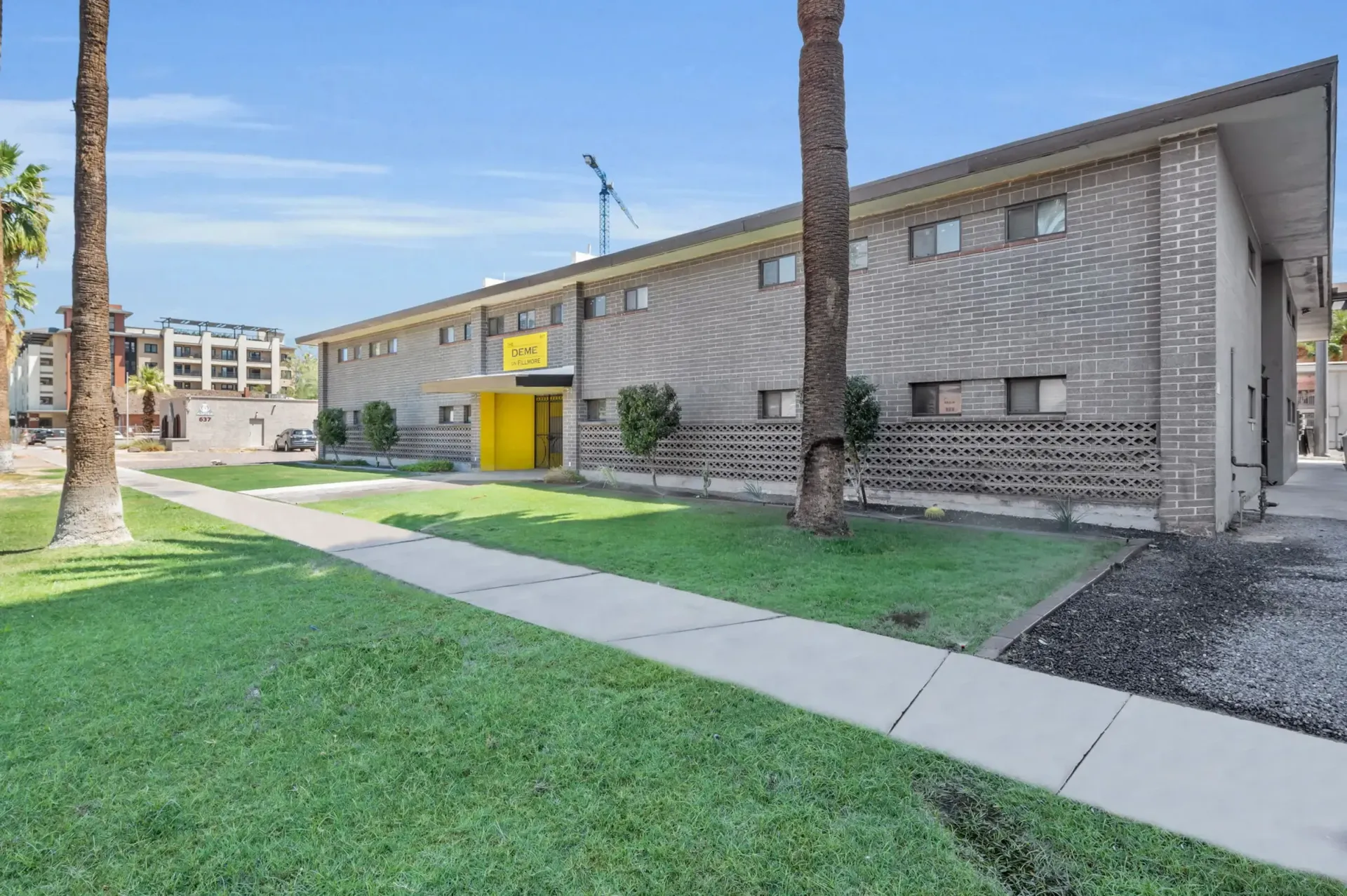 a brick building with a yellow sign on the side that says ' studio '