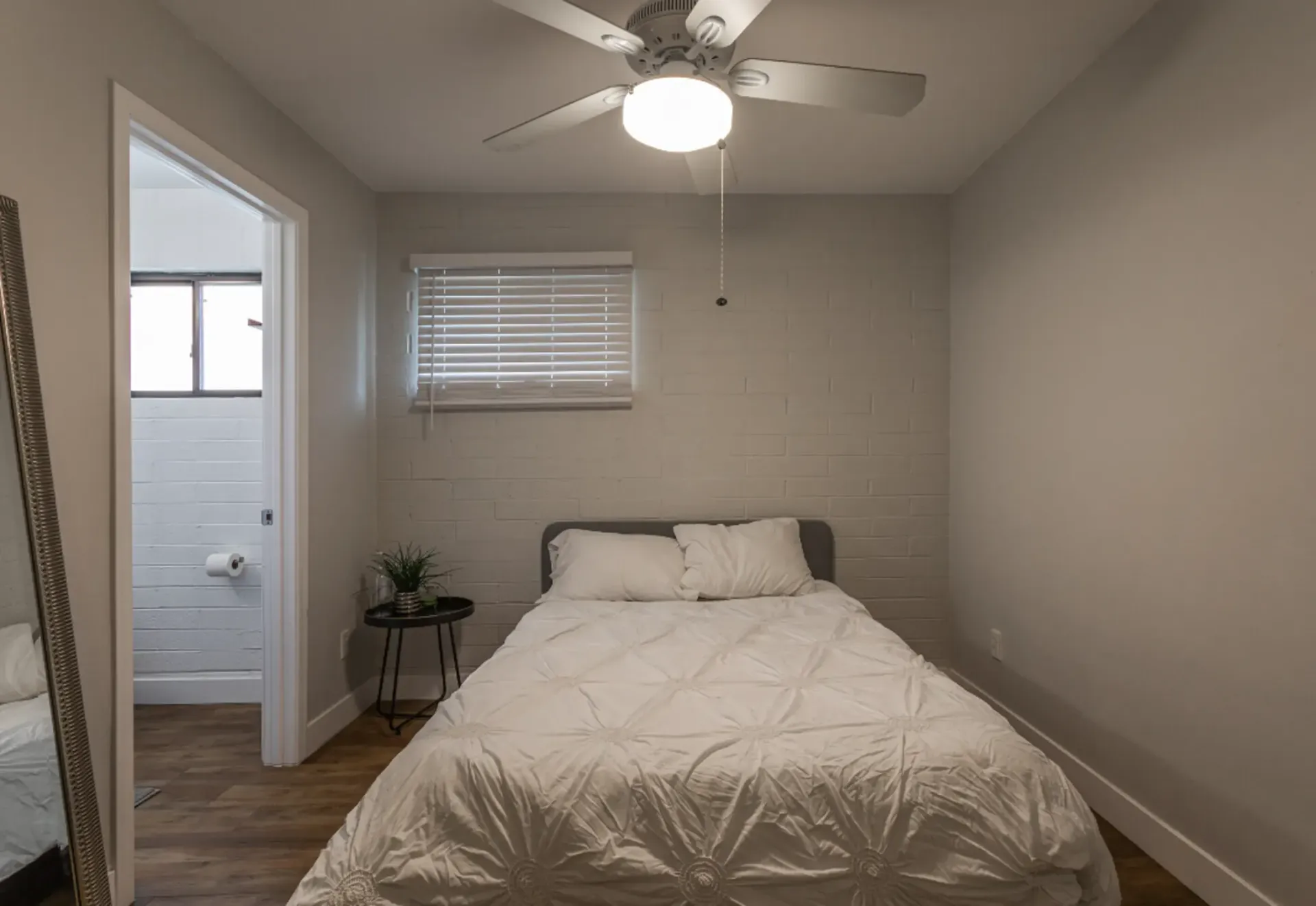a bedroom with a bed and a ceiling fan