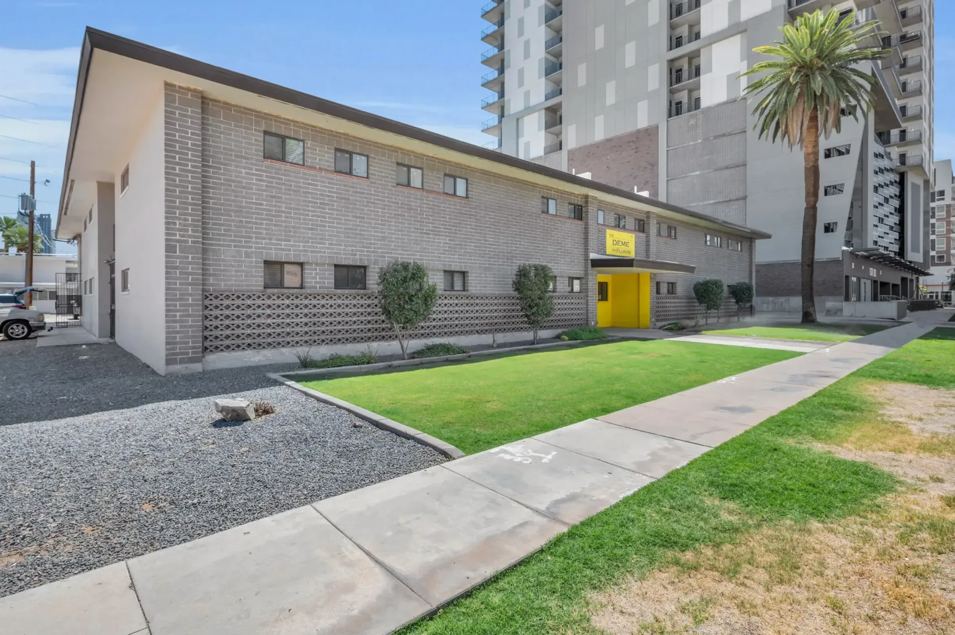 a brick building with a yellow door and a sign that says office