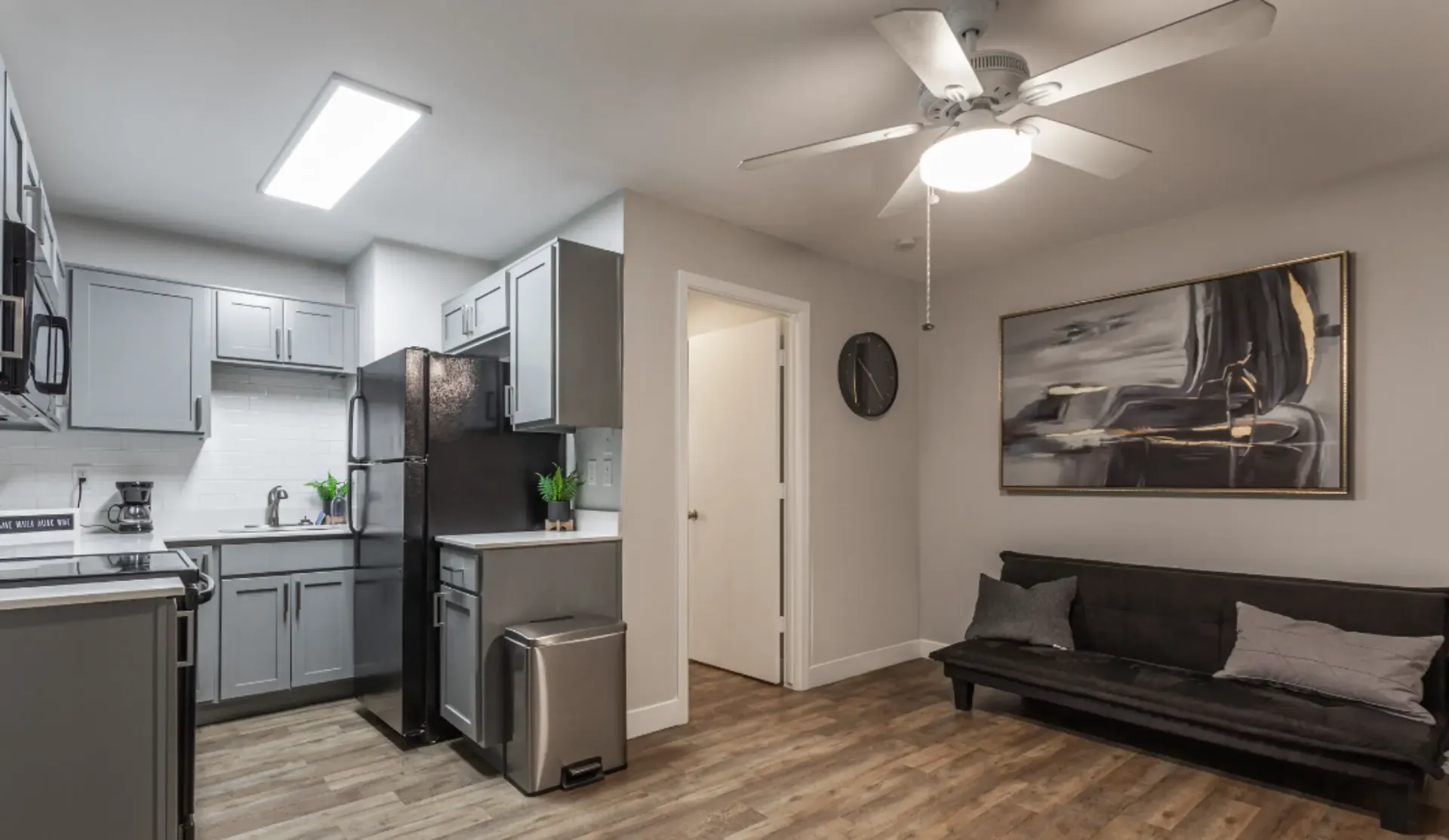 a living room with a couch and a ceiling fan