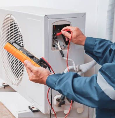 A man is working on an air conditioner with a multimeter.