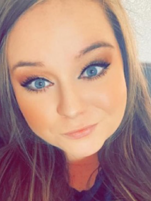 A close up of a woman 's face with blue eyes