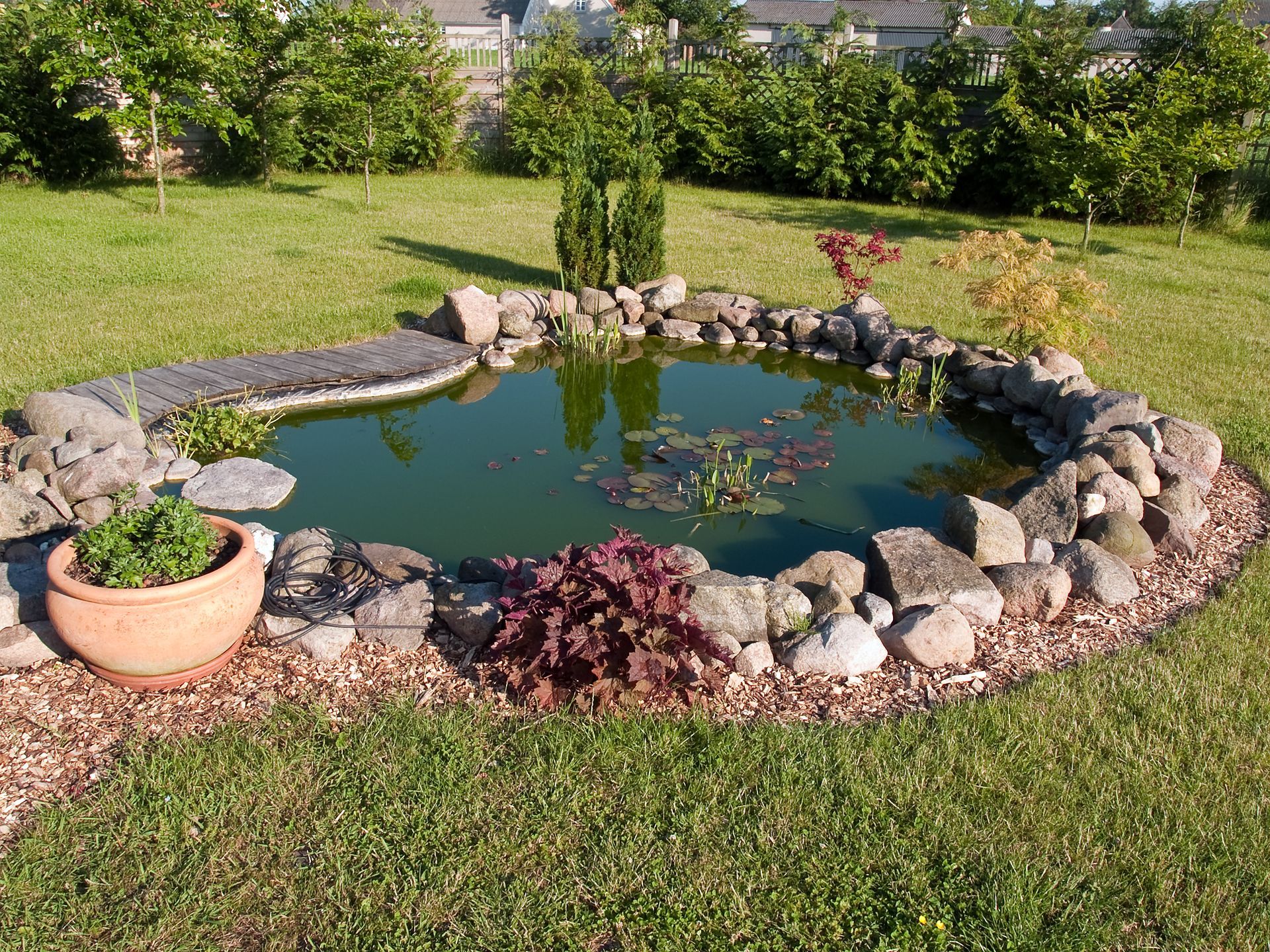  Fish pond built in the courtyard of a commercial clients business surrounded by grass