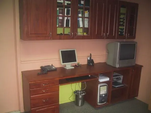 A desk with a computer and a tv on it
