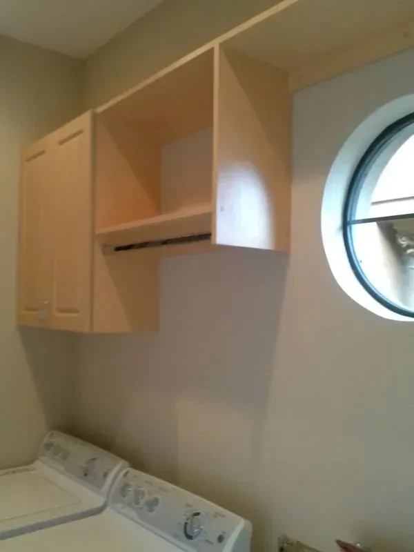A laundry room with a washer and dryer and a window