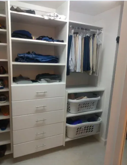 A closet filled with clothes and laundry baskets