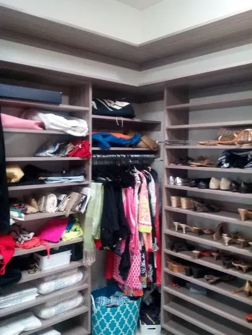 A walk in closet filled with clothes and shoes