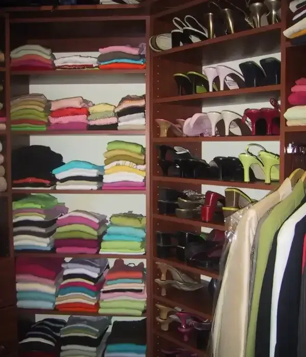 A closet filled with lots of clothes and shoes