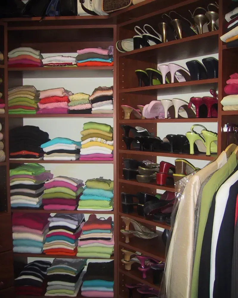 A closet filled with lots of clothes and shoes