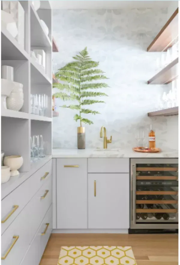 A kitchen with white cabinets and a stainless steel refrigerator