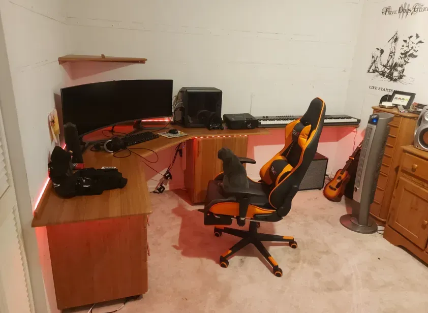 A room with a computer desk and chair