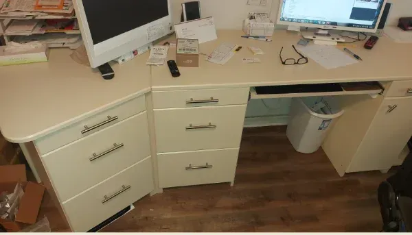 A desk with drawers and a computer on it
