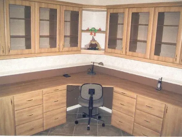 A desk with a chair and a phone on it