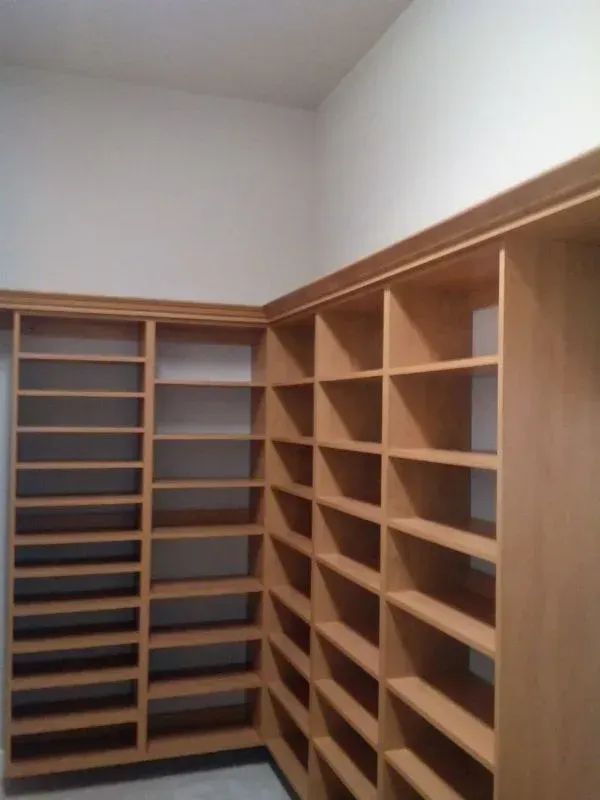 A closet with lots of shelves and a white wall