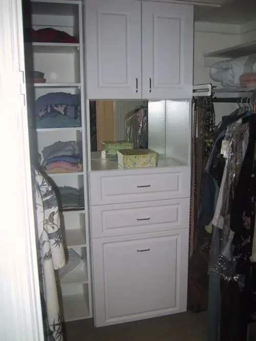A closet filled with clothes and a mirror