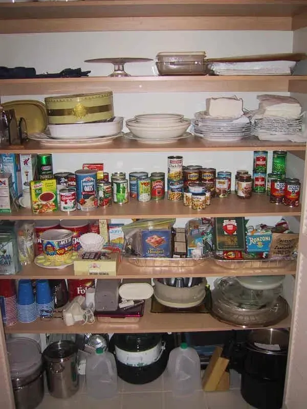 A pantry filled with a variety of food items including canned tomatoes