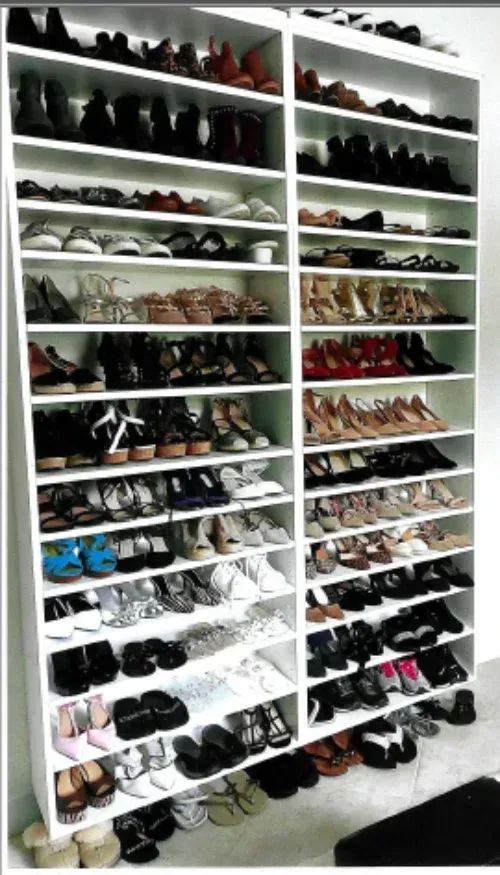 A closet filled with lots of shoes on shelves