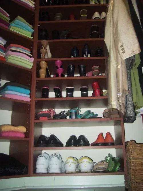 A closet filled with lots of shoes and clothes