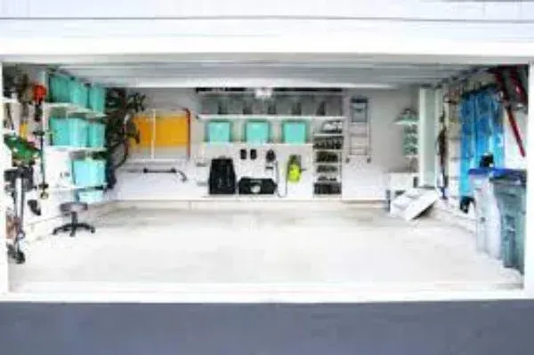 A garage filled with lots of storage space and a bicycle.