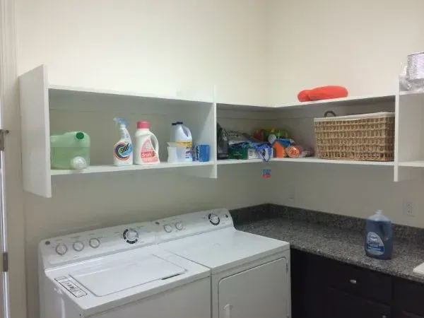 A laundry room with a washer and dryer in it