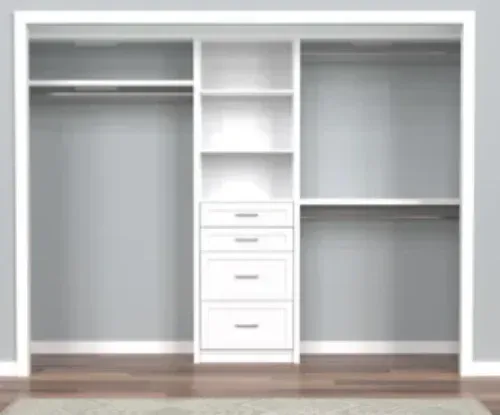An empty closet with white shelves and drawers in a bedroom.