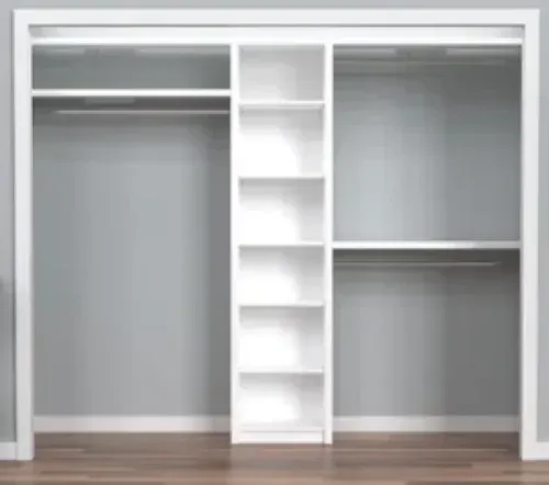A closet with a lot of shelves and hanging clothes in it.