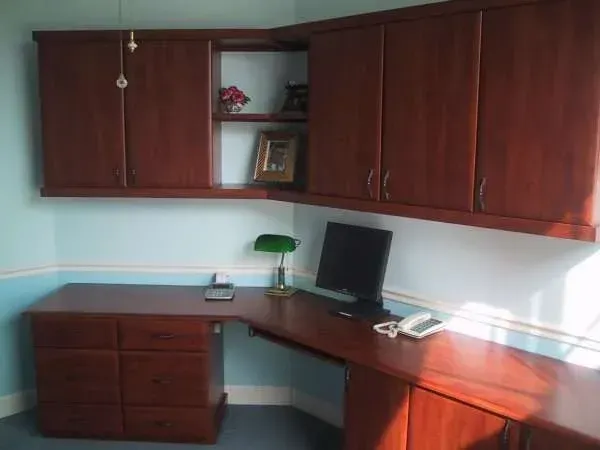 A desk with a computer and a phone on it