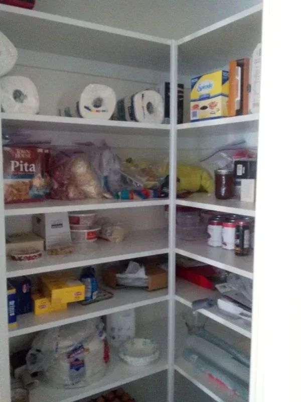 A pita box sits on a shelf in a pantry