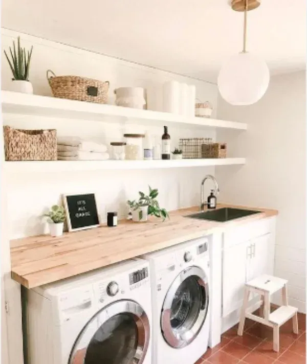 A laundry room with a washer and dryer and a sink.