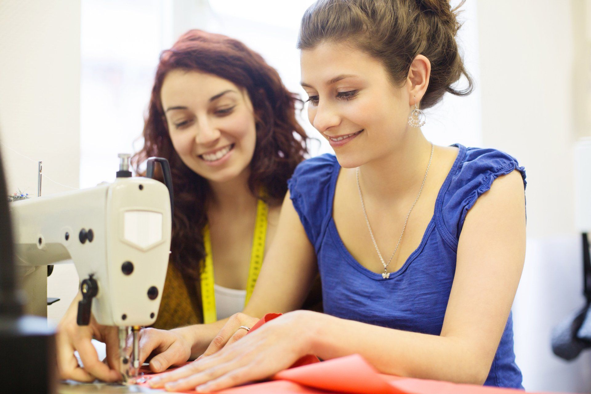 Two Women Using A Sewing Machine - Pooler, GA - Moye's Sewing Centers Inc