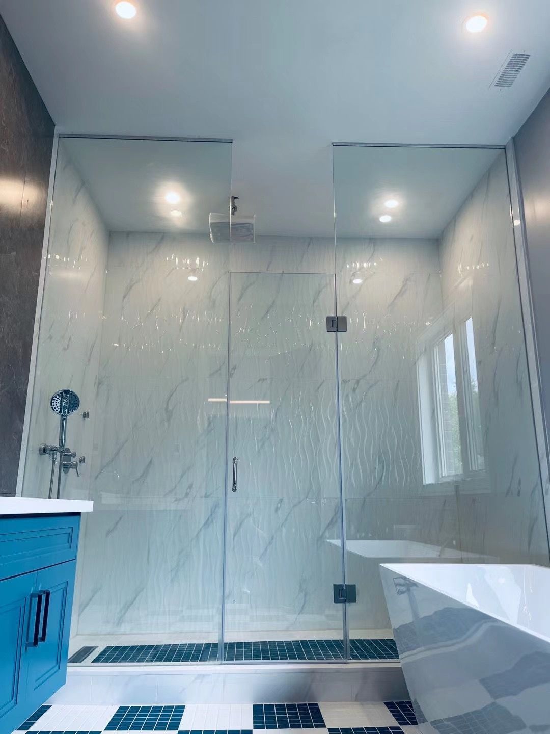 A bathroom with a walk in shower and a bathtub.