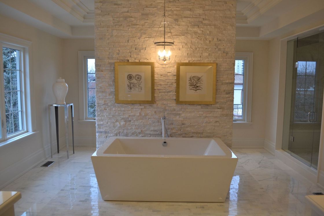 There is a bathtub in the middle of the bathroom.