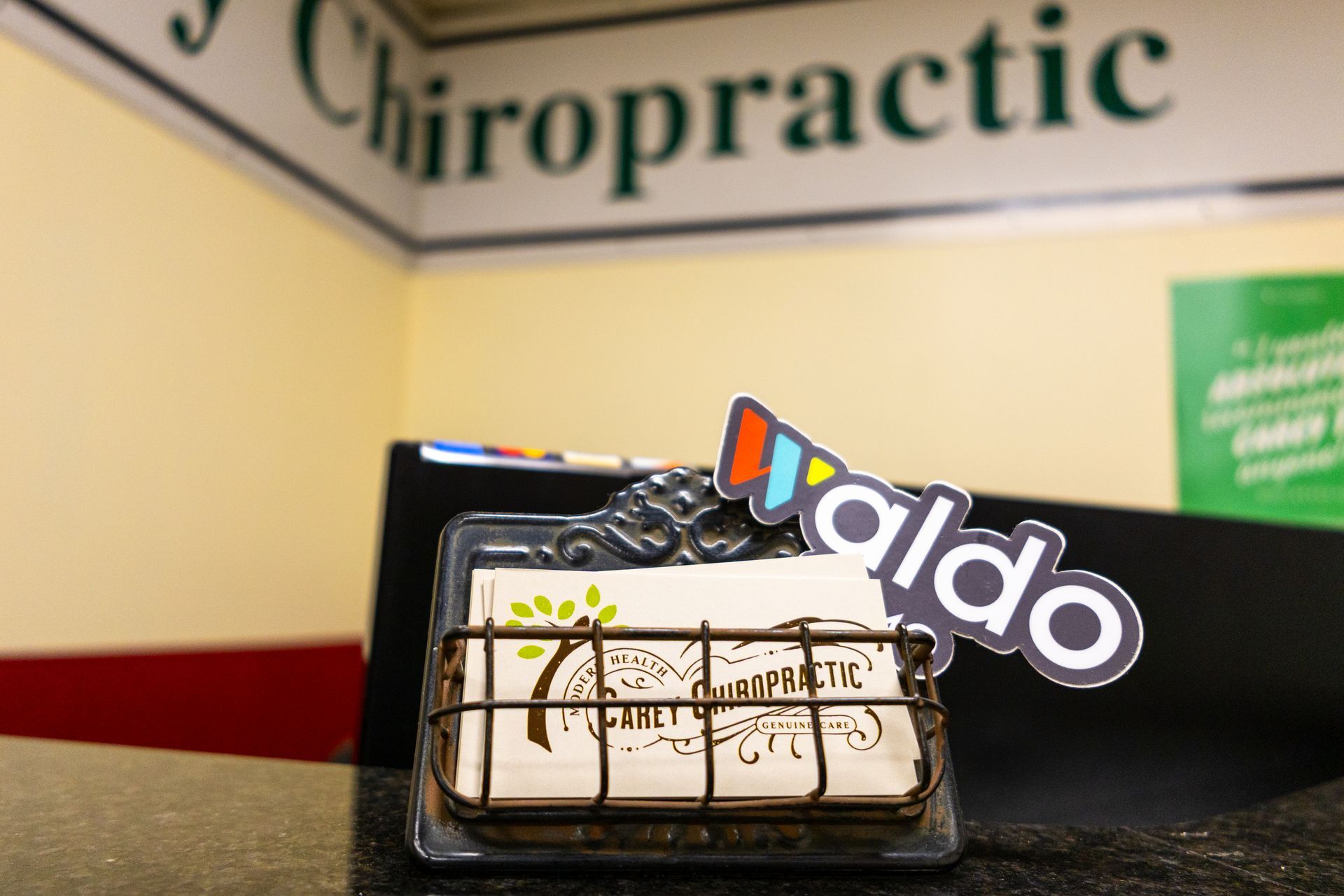 Business card holder with logo in chiropractic office.
