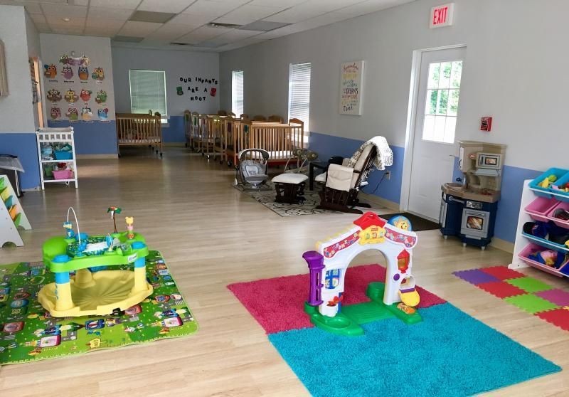 A room with a lot of toys and cribs in it.