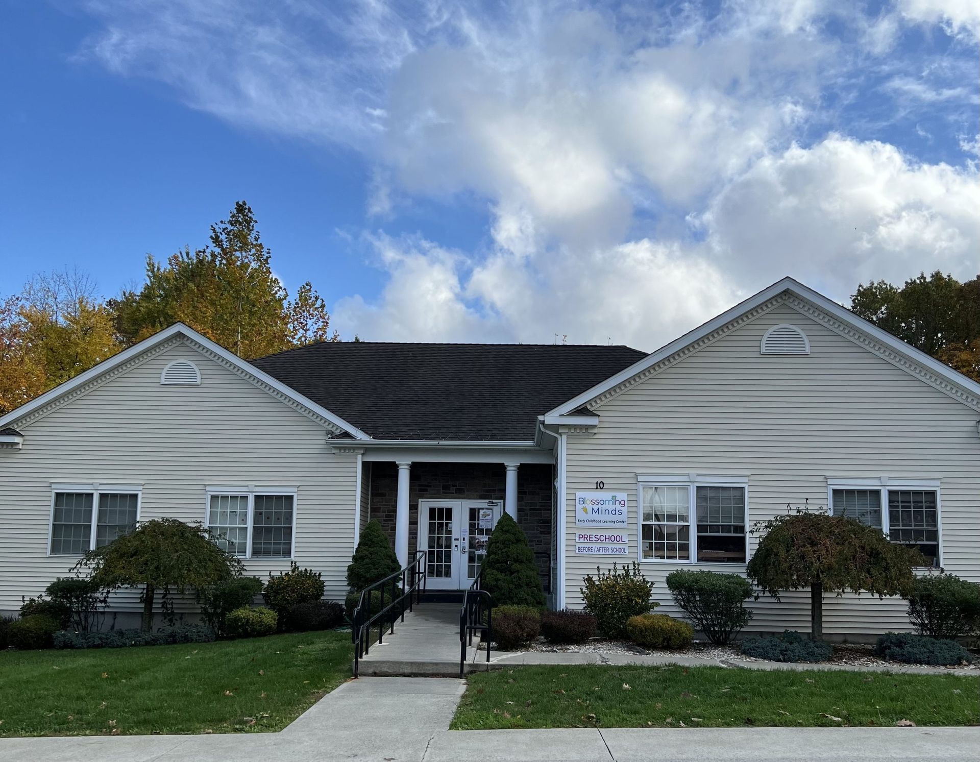 A large white house with a black roof