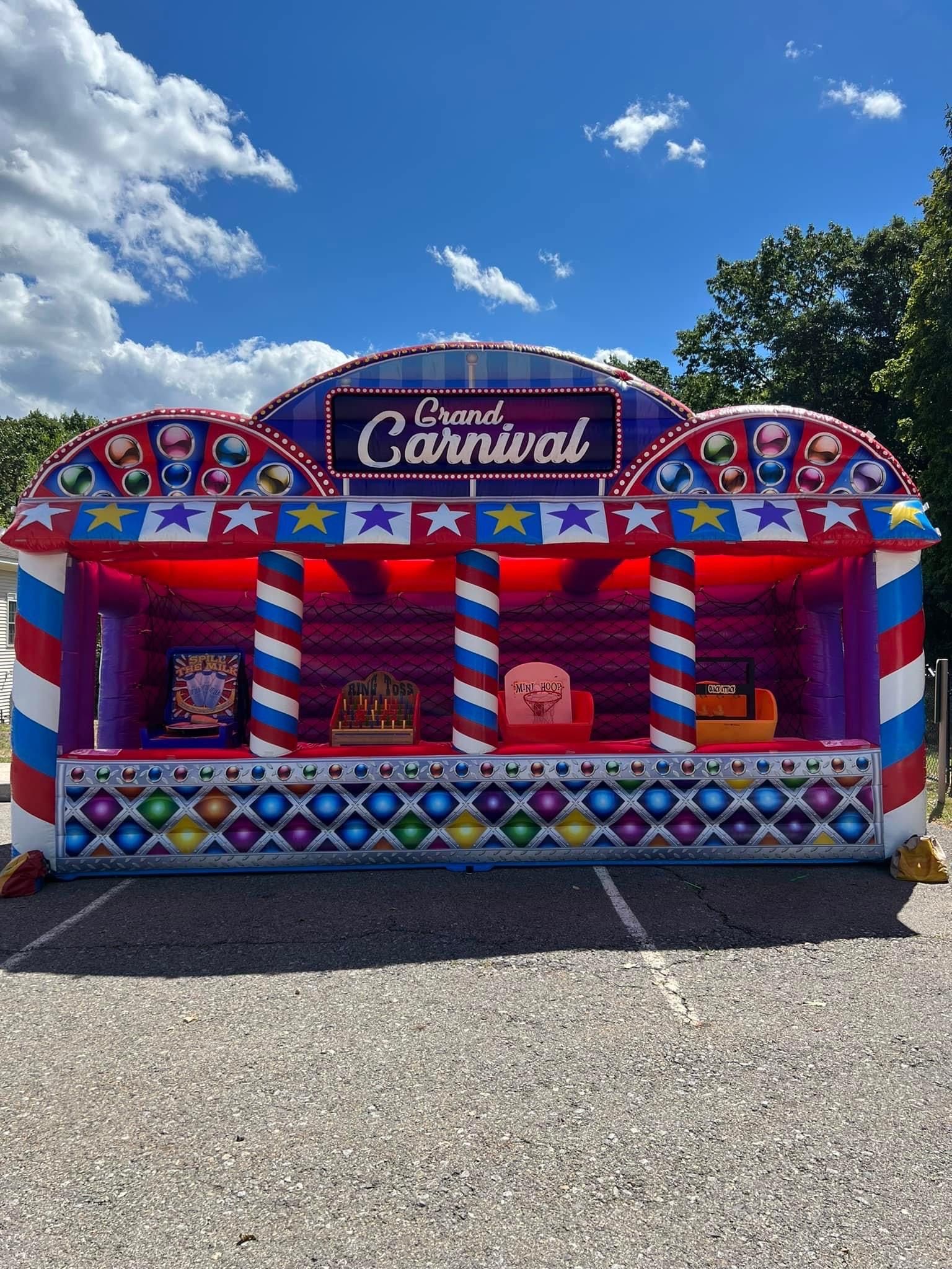 A carnival booth is sitting in a parking lot.