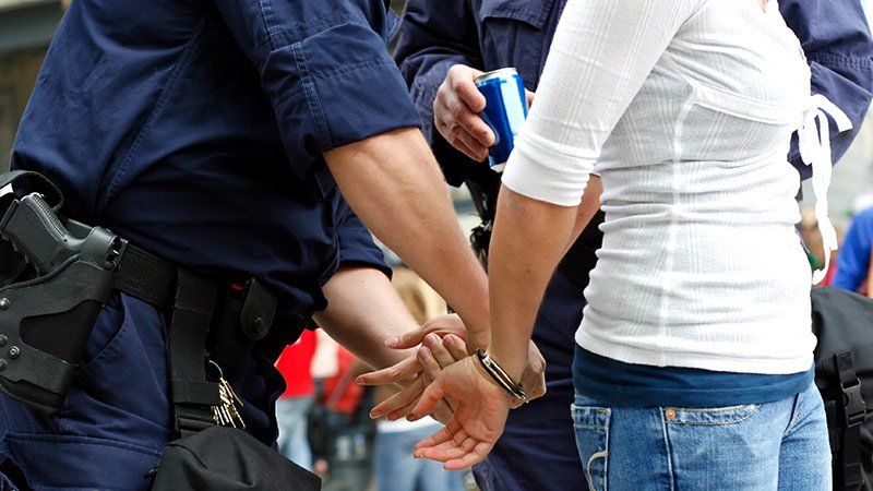 person being handcuffed by police officer