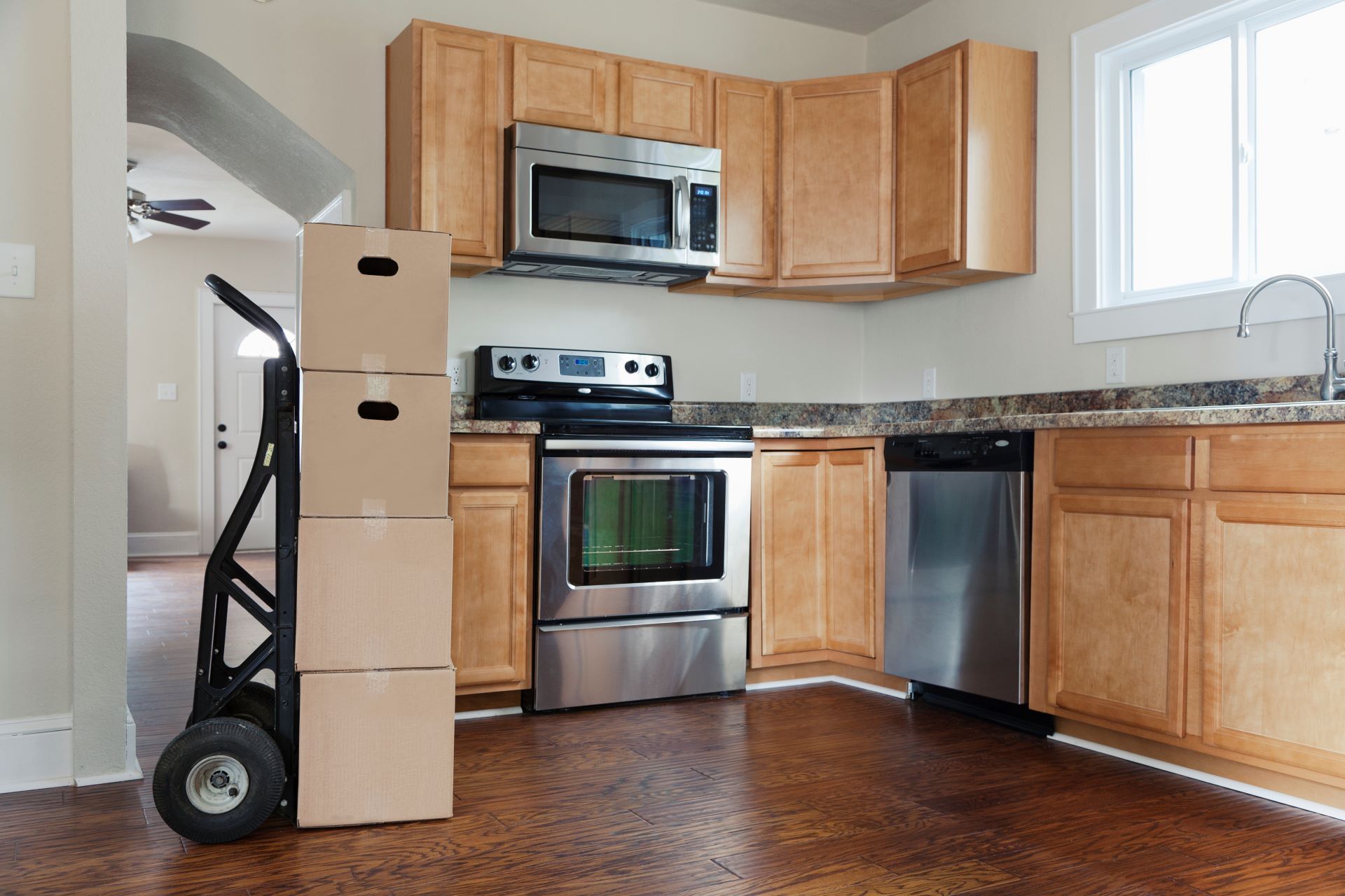 A kitchen with stainless steel appliances and wooden cabinets