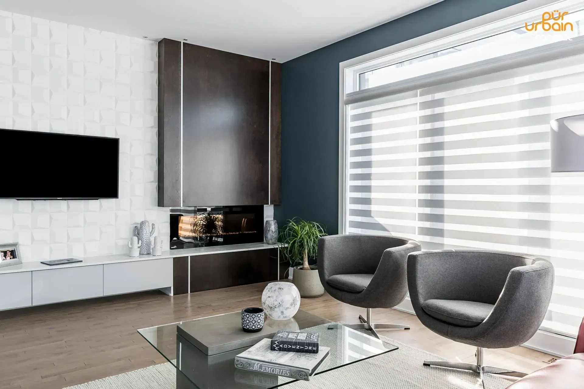 A living room with two chairs , a coffee table , a television and a fireplace.