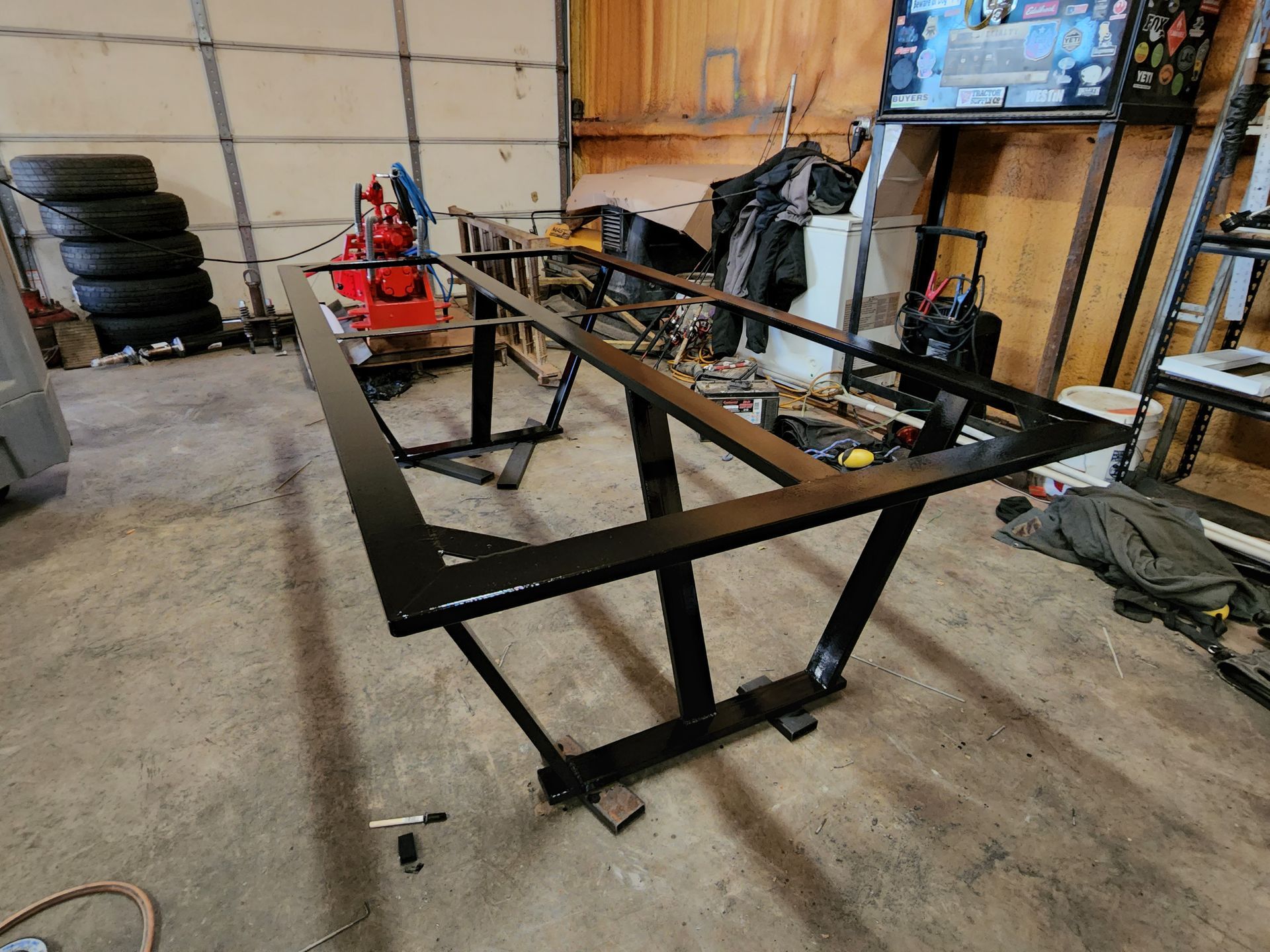 A metal table is being built in a garage.