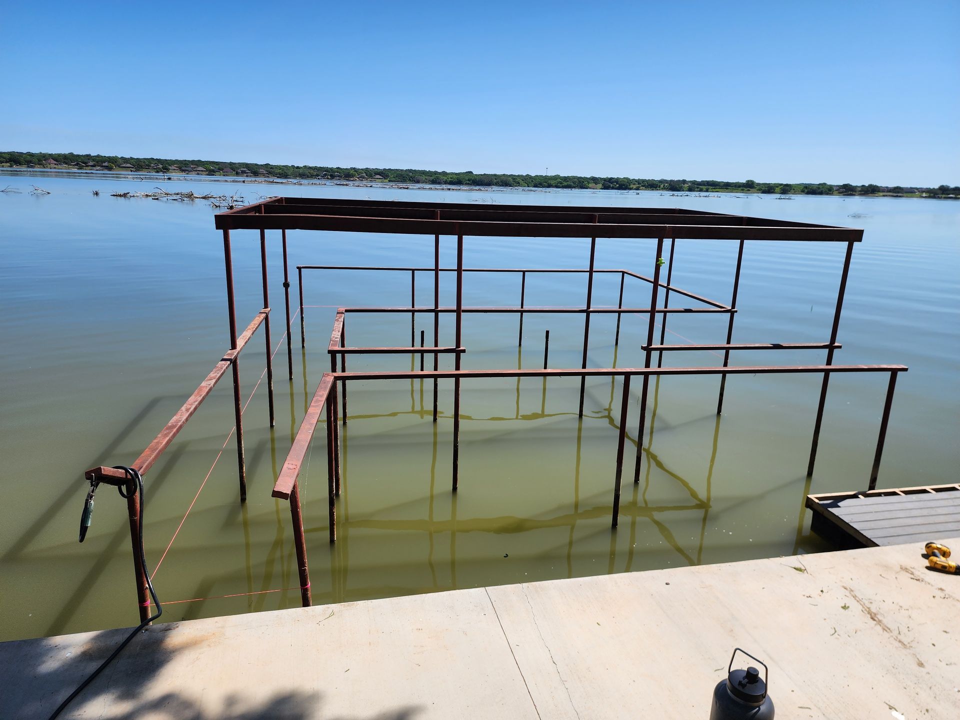 A large body of water with a dock in the foreground