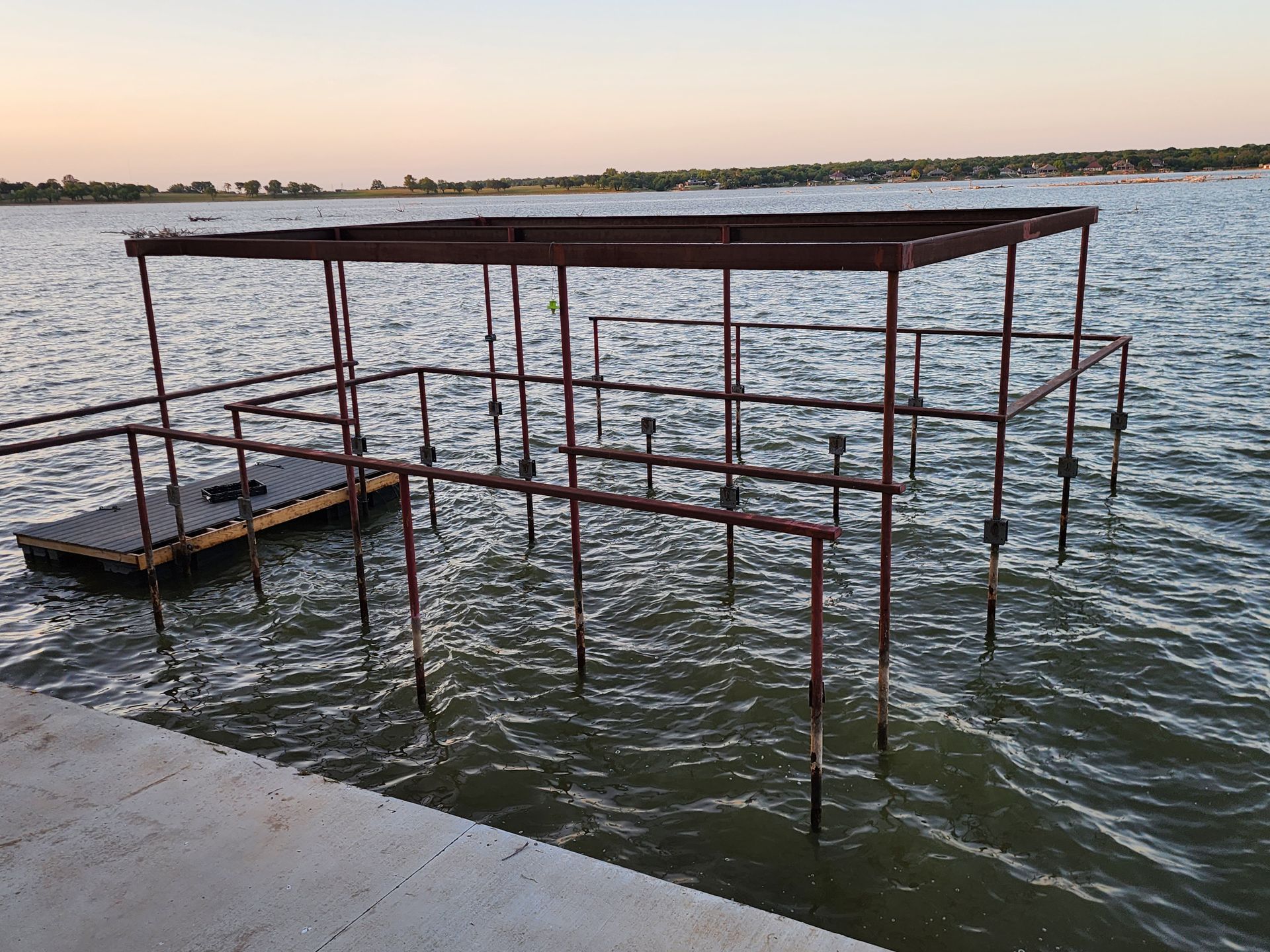 A dock is floating in the middle of a lake.
