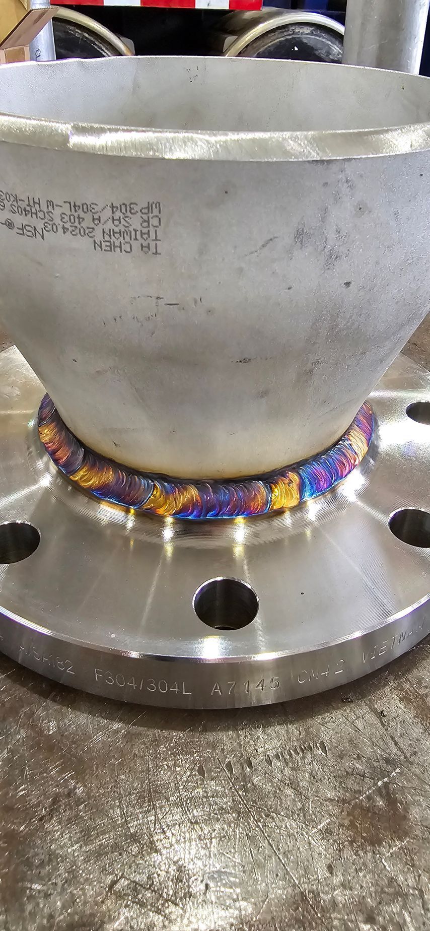 A close up of a metal object with a flange on top of it.