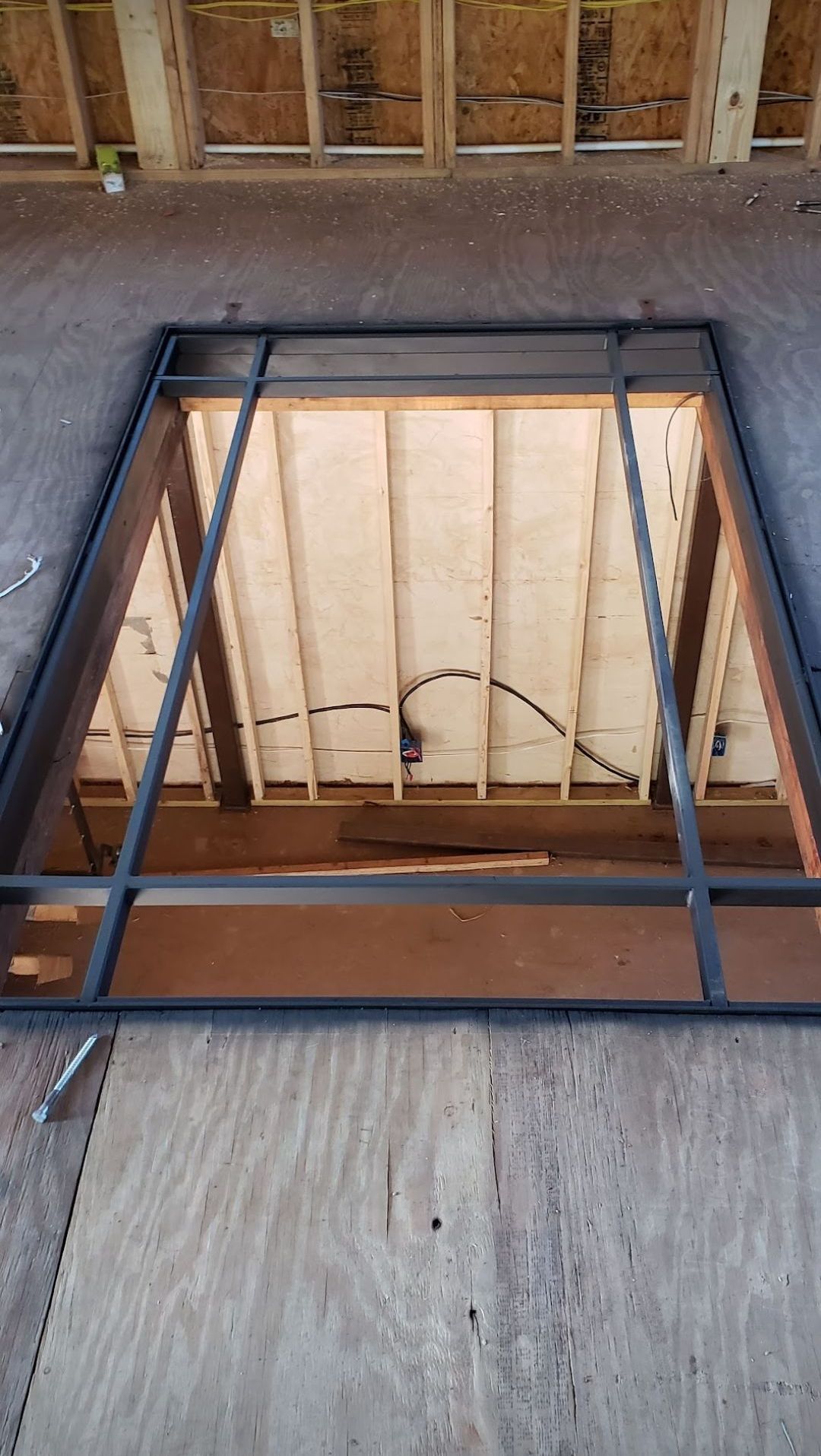 A window in the ceiling of a building under construction.