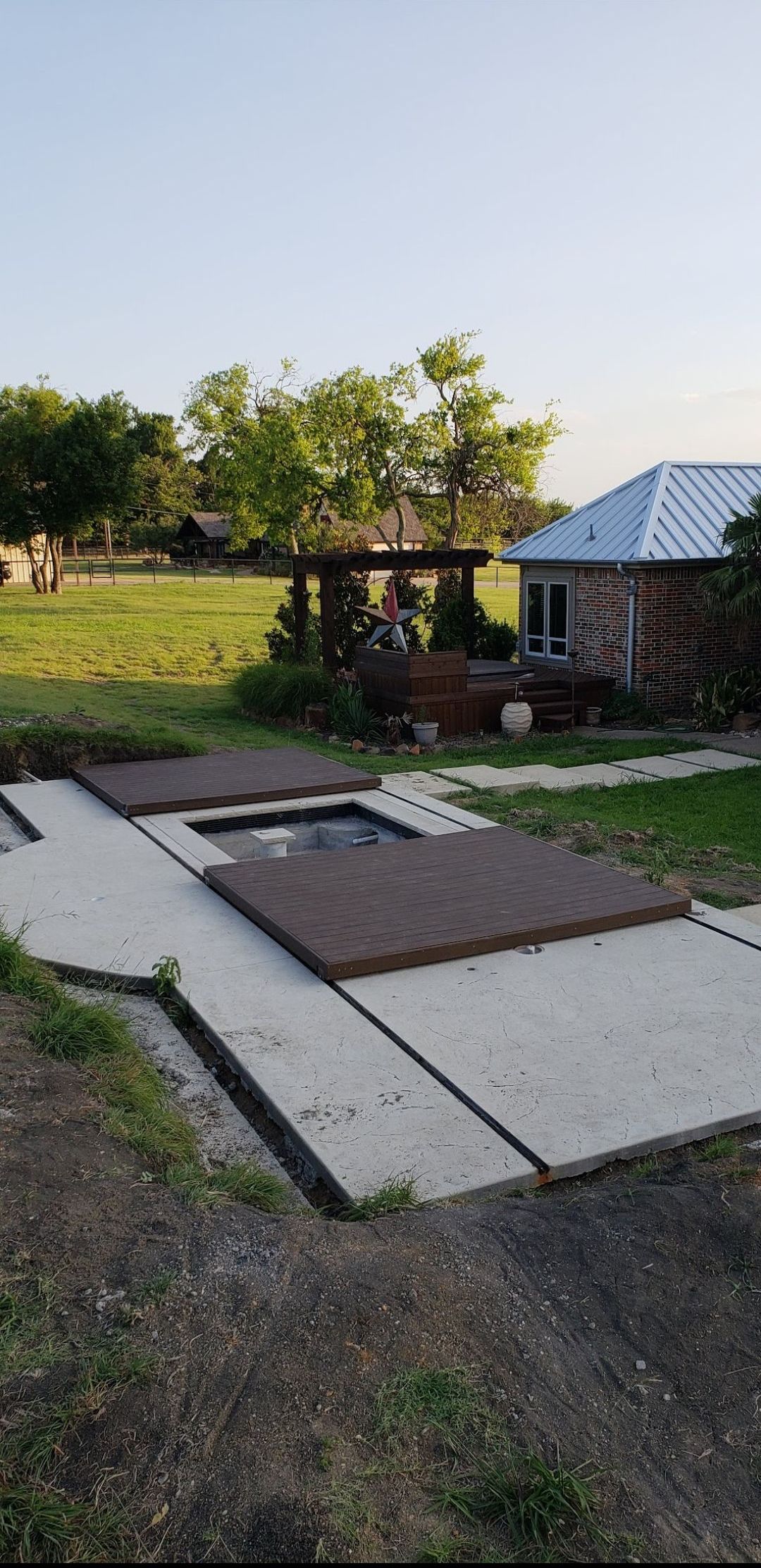 A house is sitting in the middle of a grassy field.
